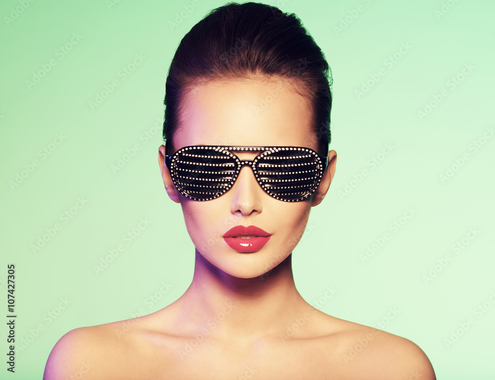 Fashion portrait of woman wearing black sunglasses with diamon Fashion portrait of woman wearing black sunglasses with diamon