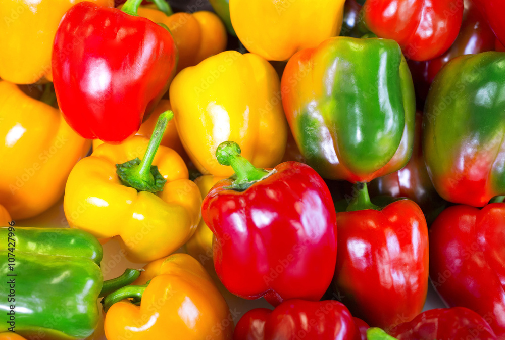 Fresh yellow, red and green colorful peppers background Fresh yellow, red and green colorful peppers background