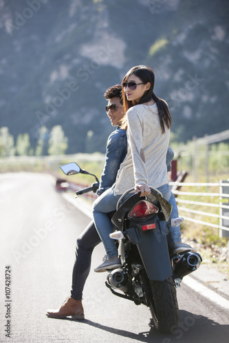 Young couple riding motorcycle together
