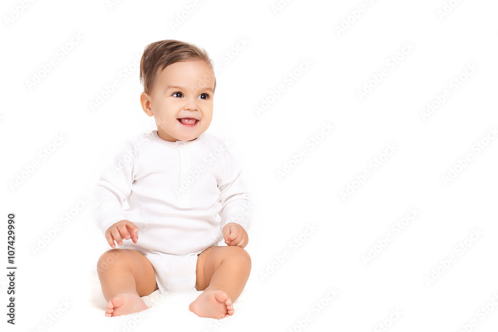 Portrait of a curious little boy,brunette with brown eyes and short hair,dressed in a white shirt and a white diaper,barefoot posing in Studio,sitting on a white background, smiling mouth open Portrait of a curious little boy,brunette with brown eyes and short hair,dressed in a white shirt and a white diaper,barefoot posing in Studio,sitting on a white background, smiling mouth open