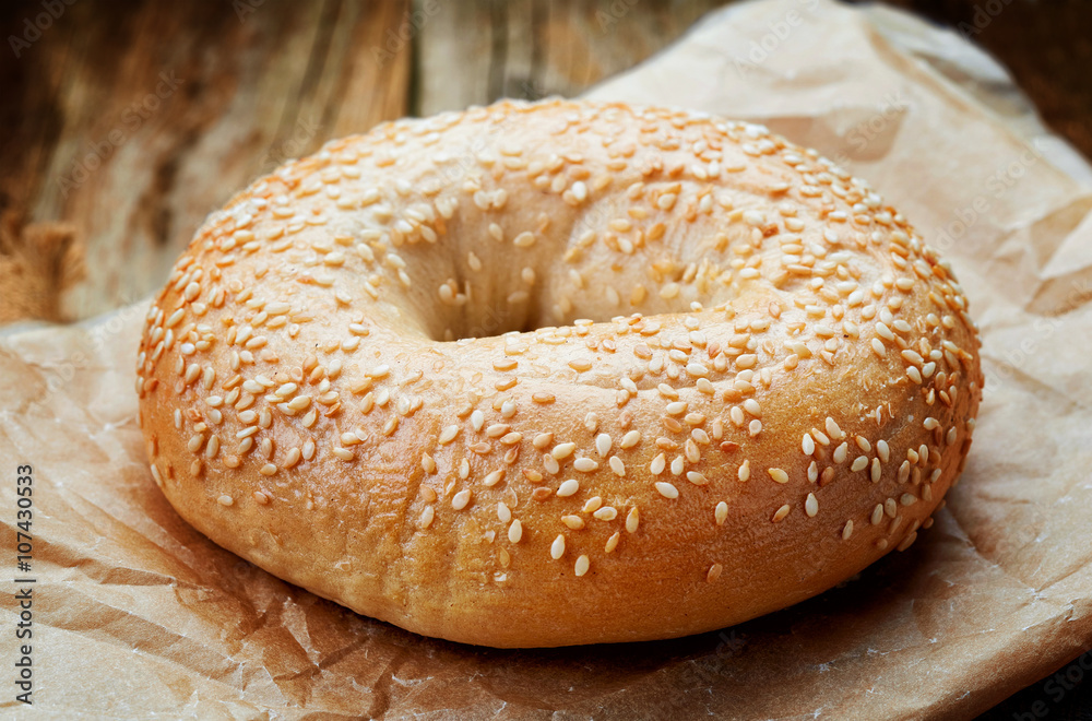 Sesame bagel on wooden table Sesame bagel on wooden table