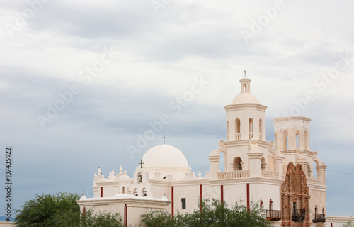 Mission San Xavier del Bac on a Cloudy Day. Mission San Xavier del Bac is a historic Spanish Catholic mission located at Tucson, Arizona.