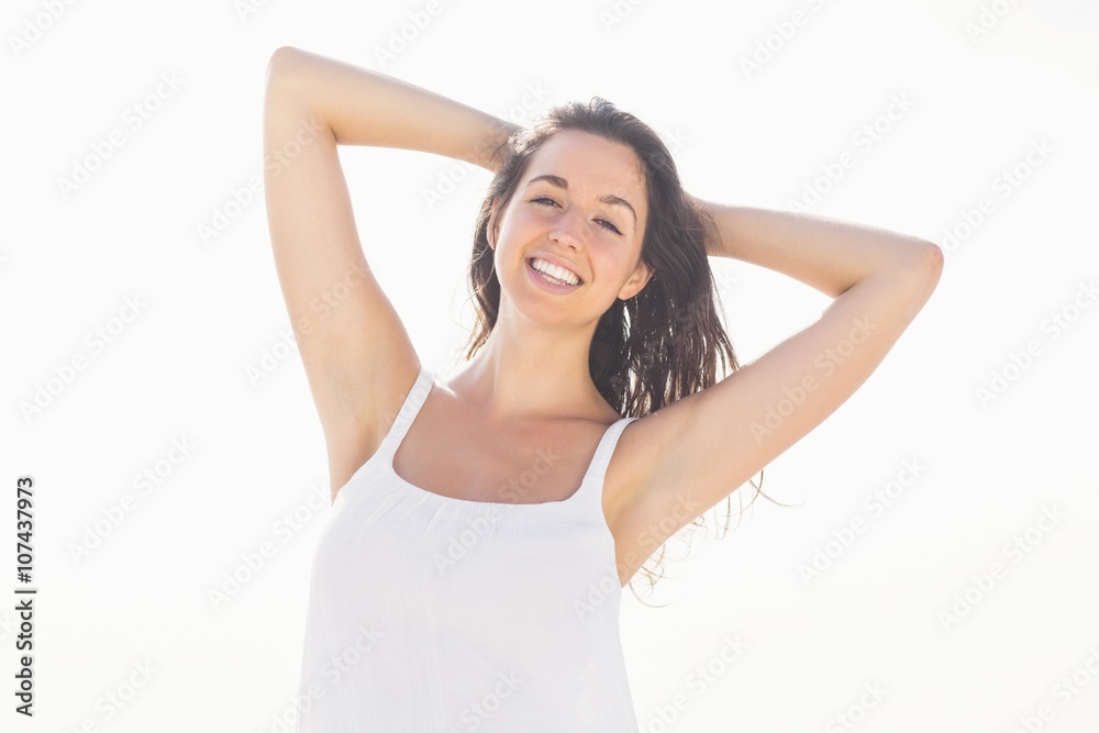 Happy woman in white outfit standing on the beach Happy woman in white outfit standing on the beach