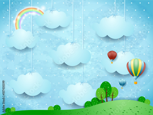 Surreal landscape with hanging clouds and hot air balloons