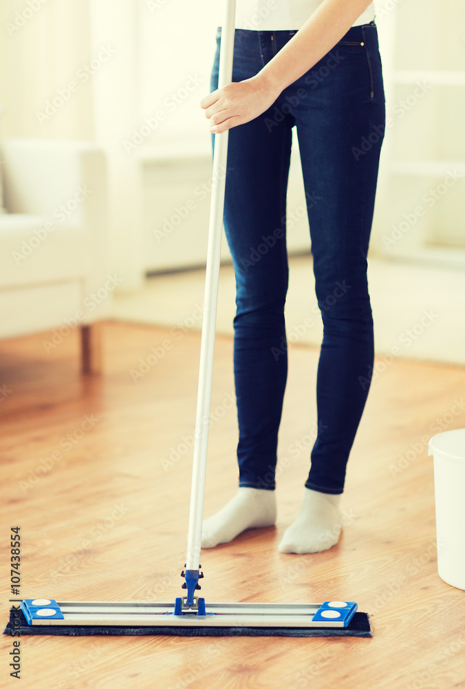 close up of woman with mop cleaning floor at home close up of woman with mop cleaning floor at home