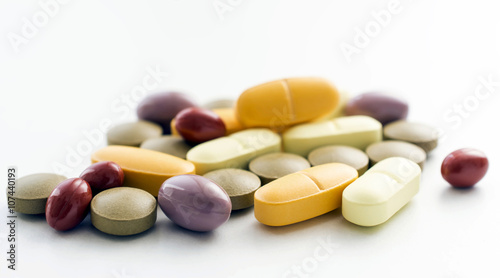 Vitamin and mineral pills on white background