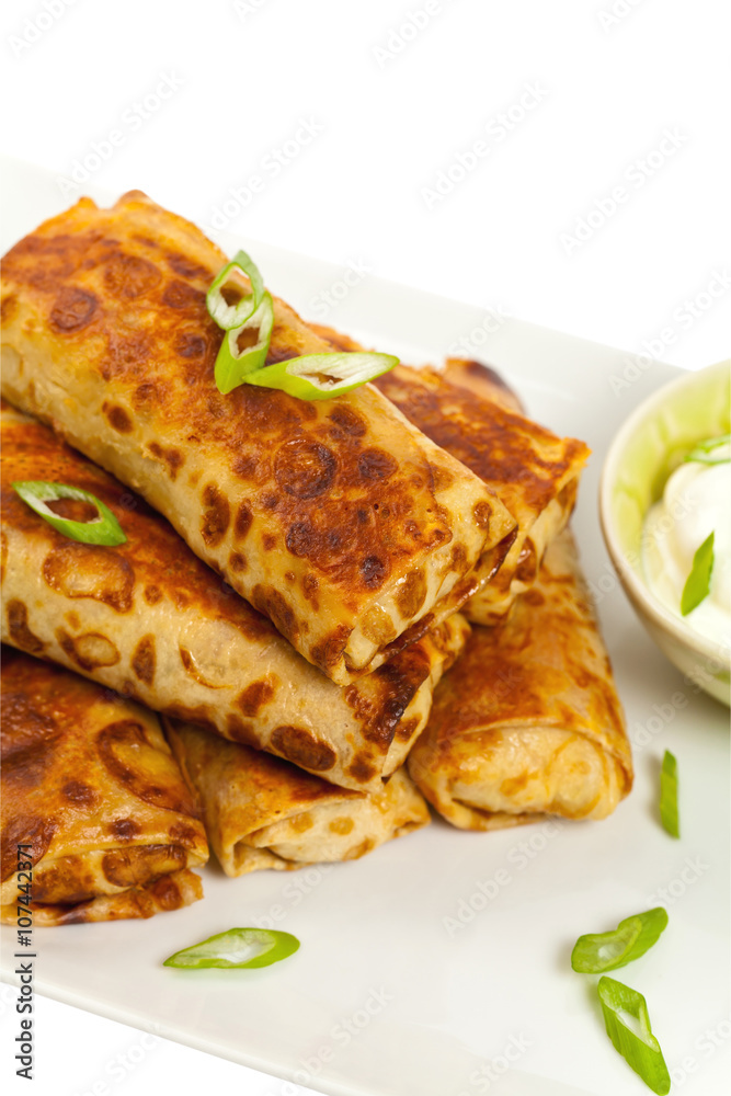 Russian Stuffed Pancakes Isolated on White. Selective focus.