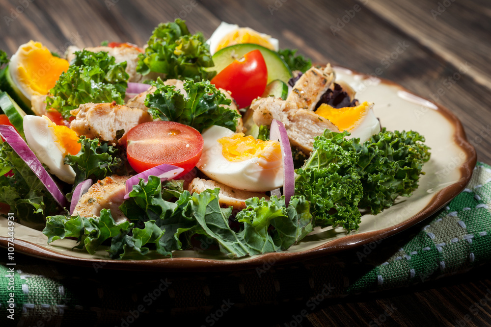 Fresh salad with chicken, tomatoes, eggs and lettuce on plate Fresh salad with chicken, tomatoes, eggs and lettuce on plate