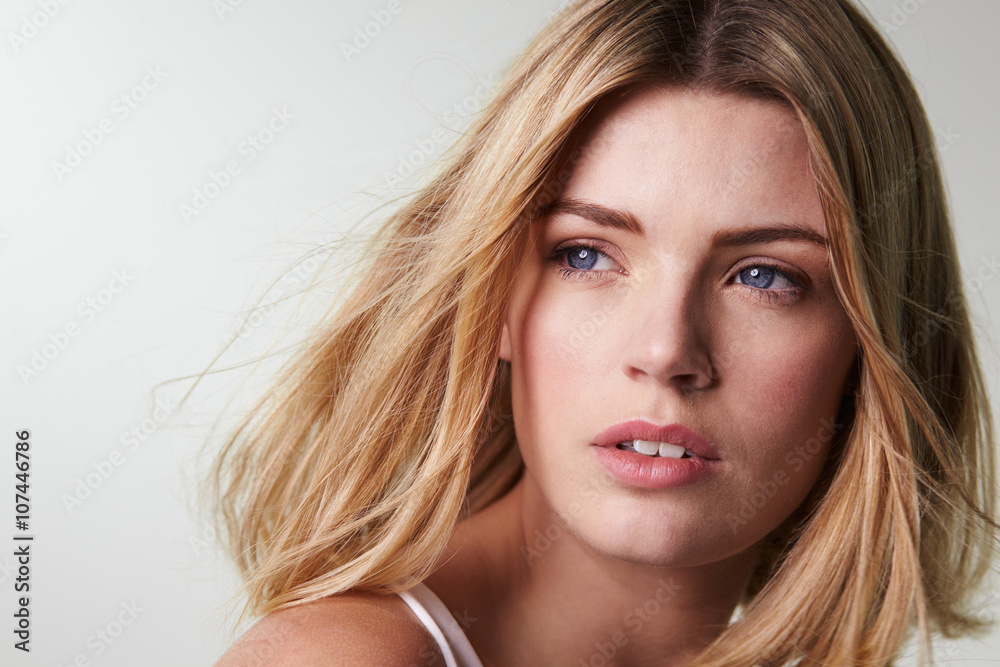 Blonde woman looking away, hair blowing, close-up horizontal Blonde woman looking away, hair blowing, close-up horizontal