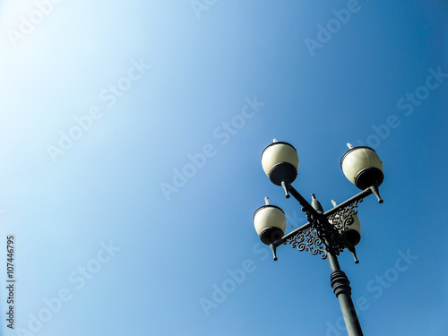 Four lamps street light blue sky background