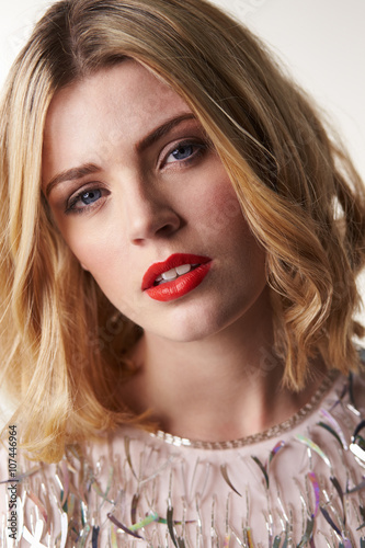 Glamorous blonde woman looking to camera, vertical portrait