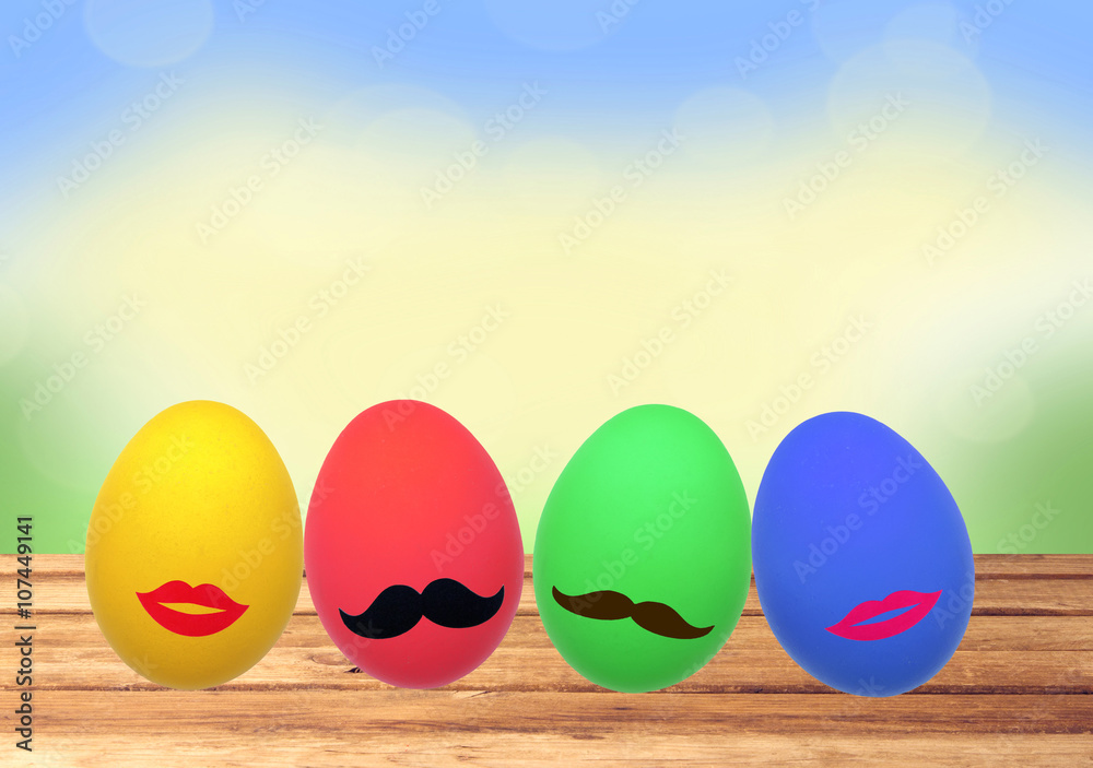 Colorful Easter eggs on wooden table over nature background