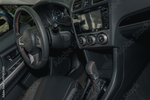 The car's interior, steering wheel