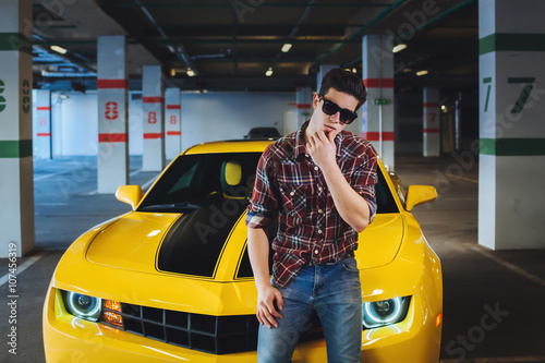 fashion portrait of sexy man in the modern sport car