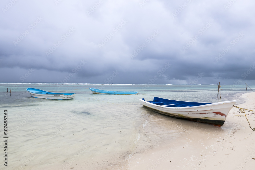 boats on a beautiful tropical beach in a rainy day