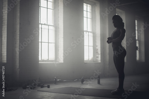 Black woman standing in dark gym photo