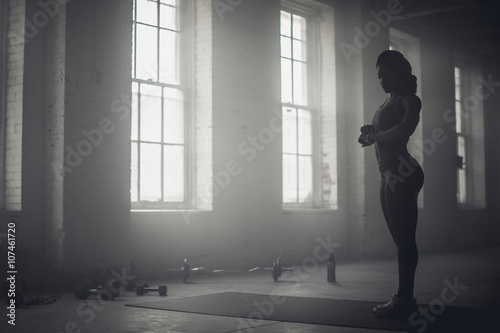 Black woman standing in dark gym