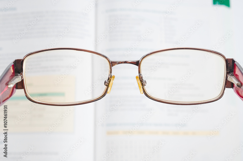 Eyeglasses and blurred textbook Eyeglasses and blurred textbook