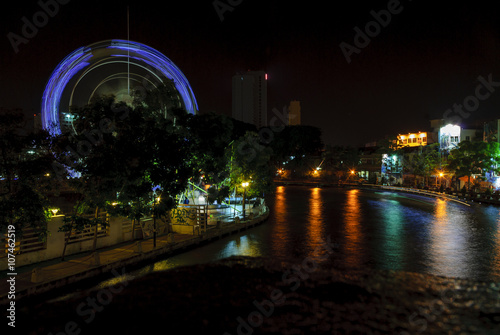 to get dark on the river Sungay Melaka to its step along the city of Melaca in Malaysia