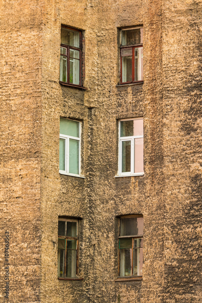 Several windows in row on facade of urban apartment building angle view, St. Petersburg, Russia.