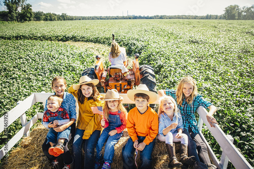 Caucasian family smiling on hay ride