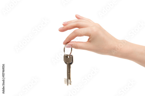 Female hand holds keys on white background.