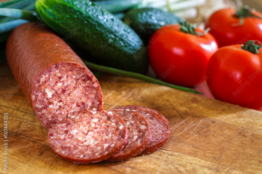 Sujuk sausage on cutting board Sujuk sausage on cutting board