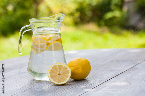 Tableau sur toile homemade citrus lemonade in pitcher with natural background