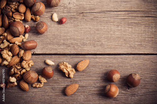 Mixed nuts on old wooden background