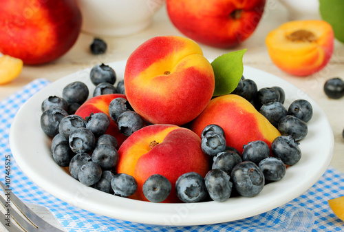 Bowl of healthy fresh fruit salad apricots and blueberries