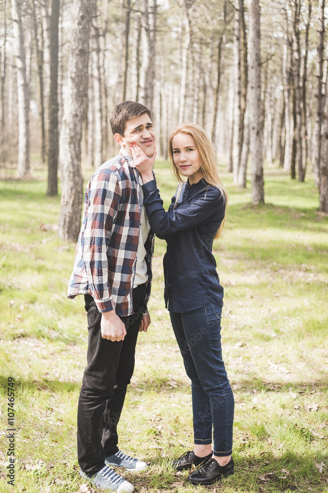 Fototapeta premium Young couple in love walking at the spring park