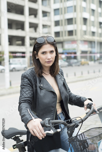 Young and beautiful woman riding bicycle outdoors © SakisPagonas