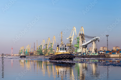 Cargo crane and tugboats in port  Saint Peterburg  Russia