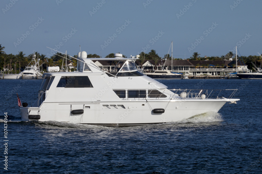 Luxury yatch in the intercoastal waterway with West Palm Beach, Florida in the background.