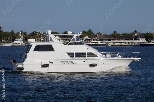 Luxury yatch in the intercoastal waterway with West Palm Beach, Florida in the background. © Aneese