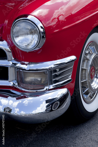 Closeup of a front classic red roaster car finder and headlight © Aneese