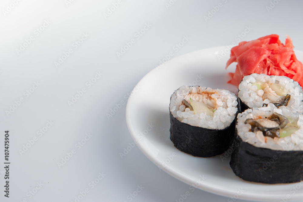 Closeup of three sushi rolls on small plate and a lot of place for text Closeup of three sushi rolls on small plate and a lot of place for text