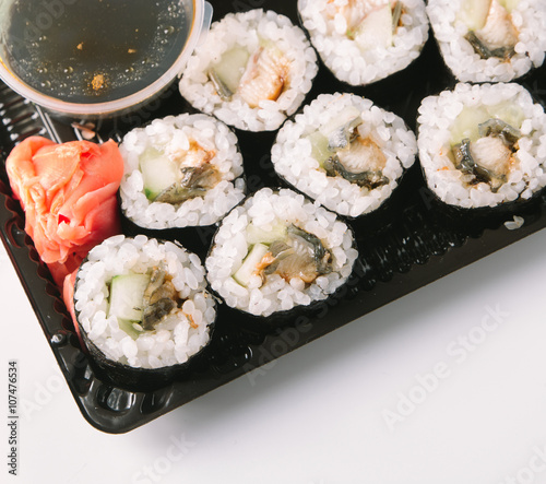 Open Sushi delivery box on white background. Top view.