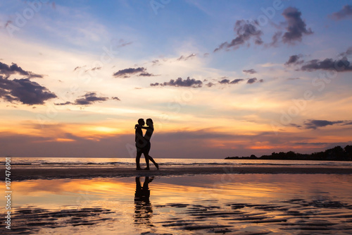 silhouette of couple on sunset beach, beautiful background about love and relationships, man and woman © Song_about_summer
