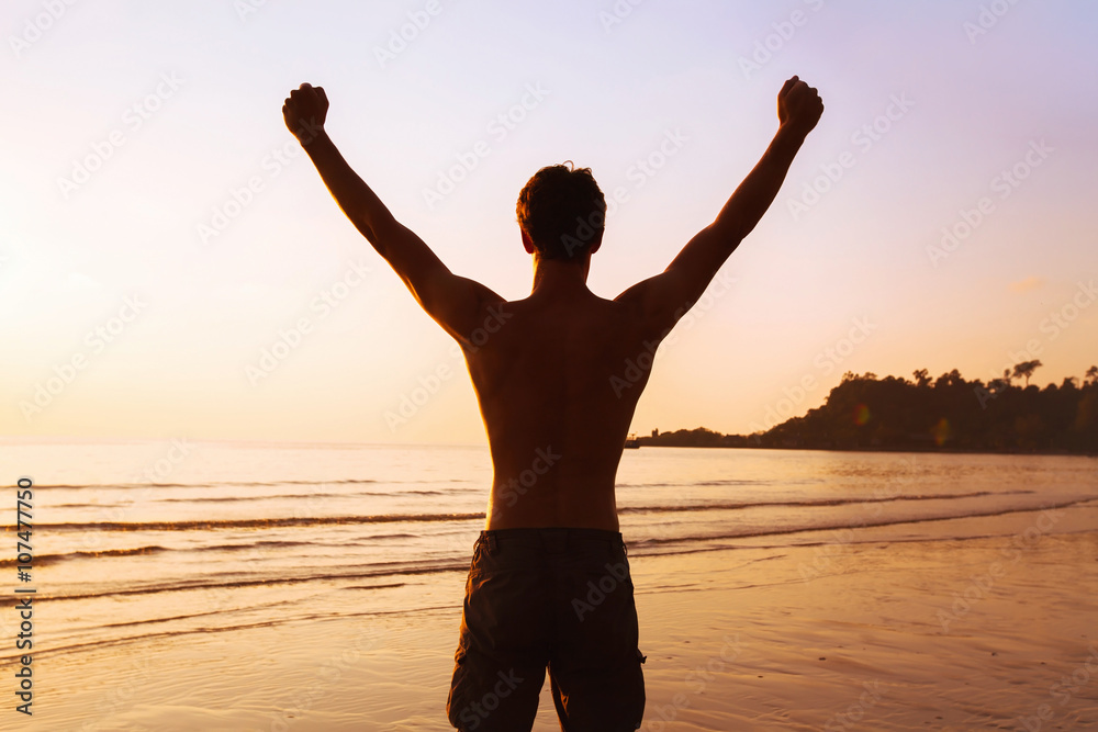 sport background, silhouette of strong sportive man on the beach, winner or achievement concept