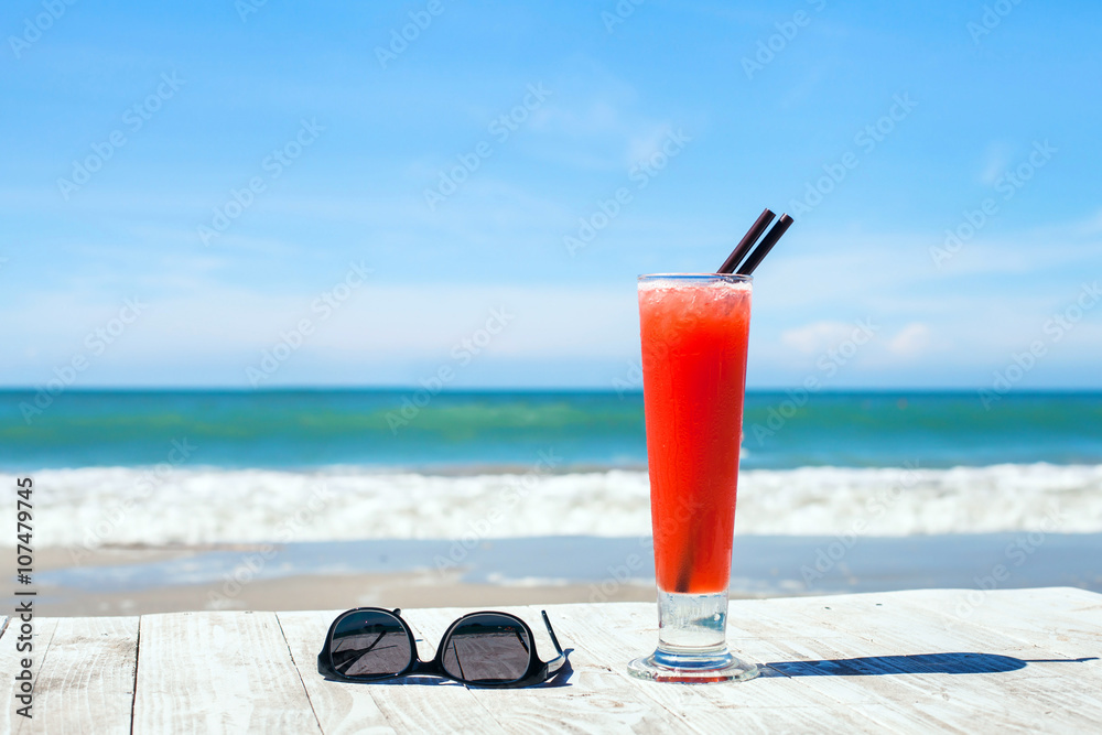 tropical vacations, background with cocktail and sunglasses on the beach