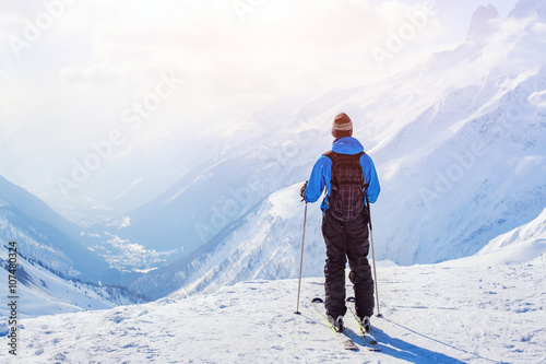 skiing in Alps, skier on beautiful mountain background at sunset