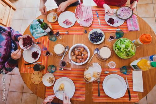 family having lunch at home, top view of the table with food, french cuisine