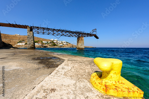 Old gantry projecting out to sea at Loutra port in Kythnos, Greece photo