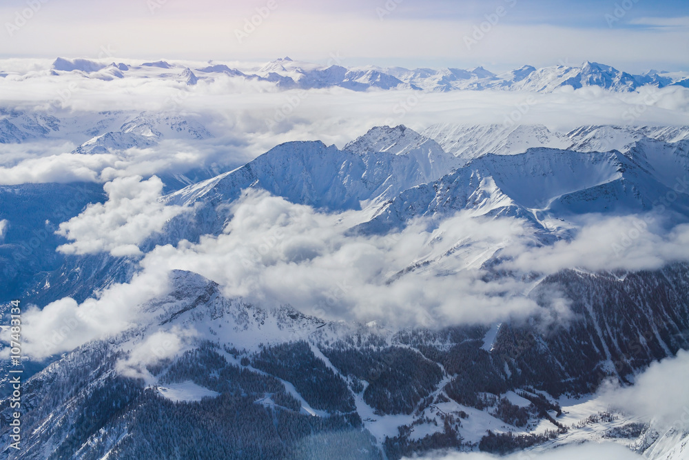 Alps, panoramic view of winter mountains with clouds above seen from Punta Helbronner Alps, panoramic view of winter mountains with clouds above seen from Punta Helbronner