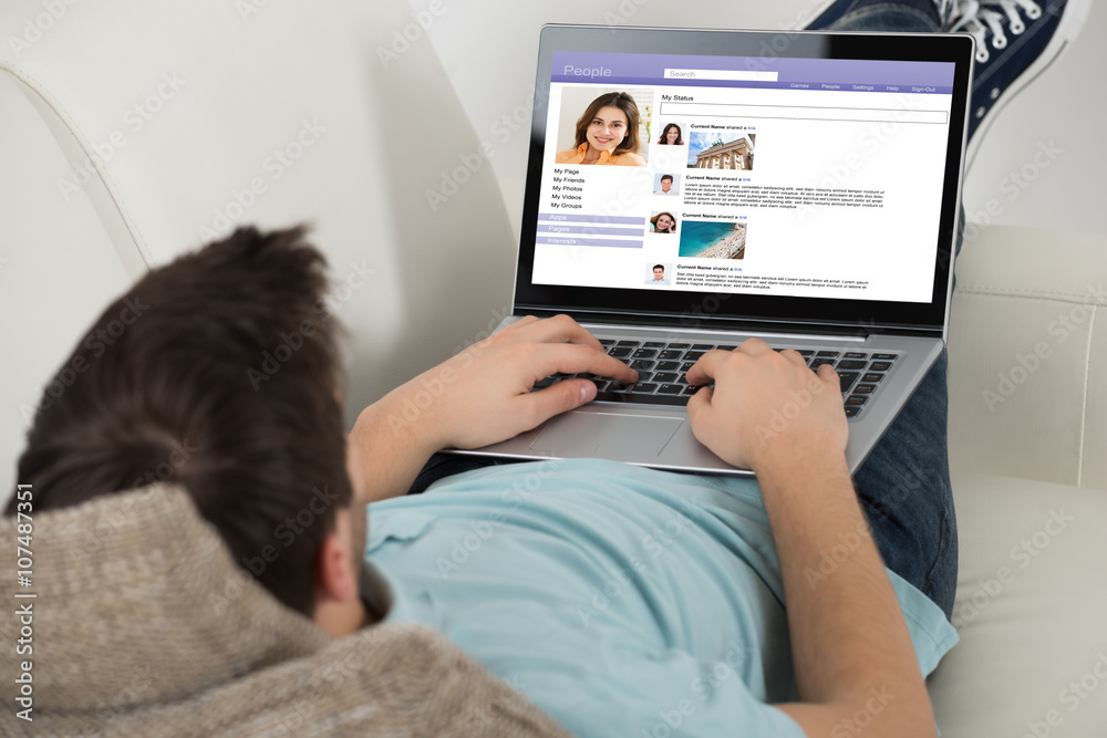Man Surfing Social Networking Site On Laptop Man Surfing Social Networking Site On Laptop