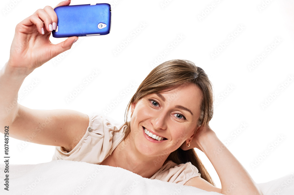 Naklejka premium smiling girl taking photo herself her mobile phone
