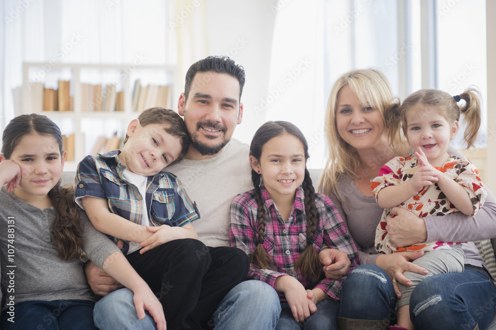 Caucasian parents and children smiling in living room Caucasian parents and children smiling in living room