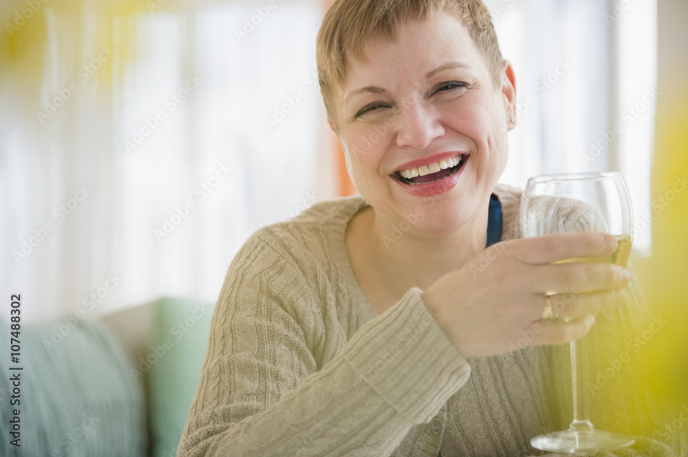 Caucasian woman drinking glass of wine on sofa Caucasian woman drinking glass of wine on sofa