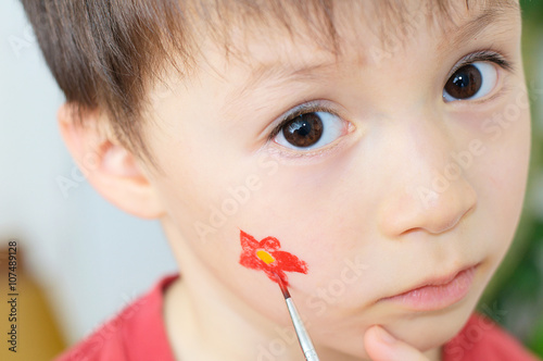 Painting  flower on child face